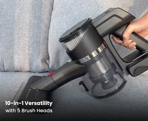 Handheld vacuum cleaner with 5 brush heads on a gray couch background