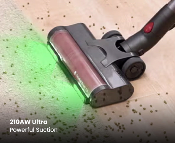 Vacuum cleaner head with powerful suction on a surface with green light highlighting the feature.